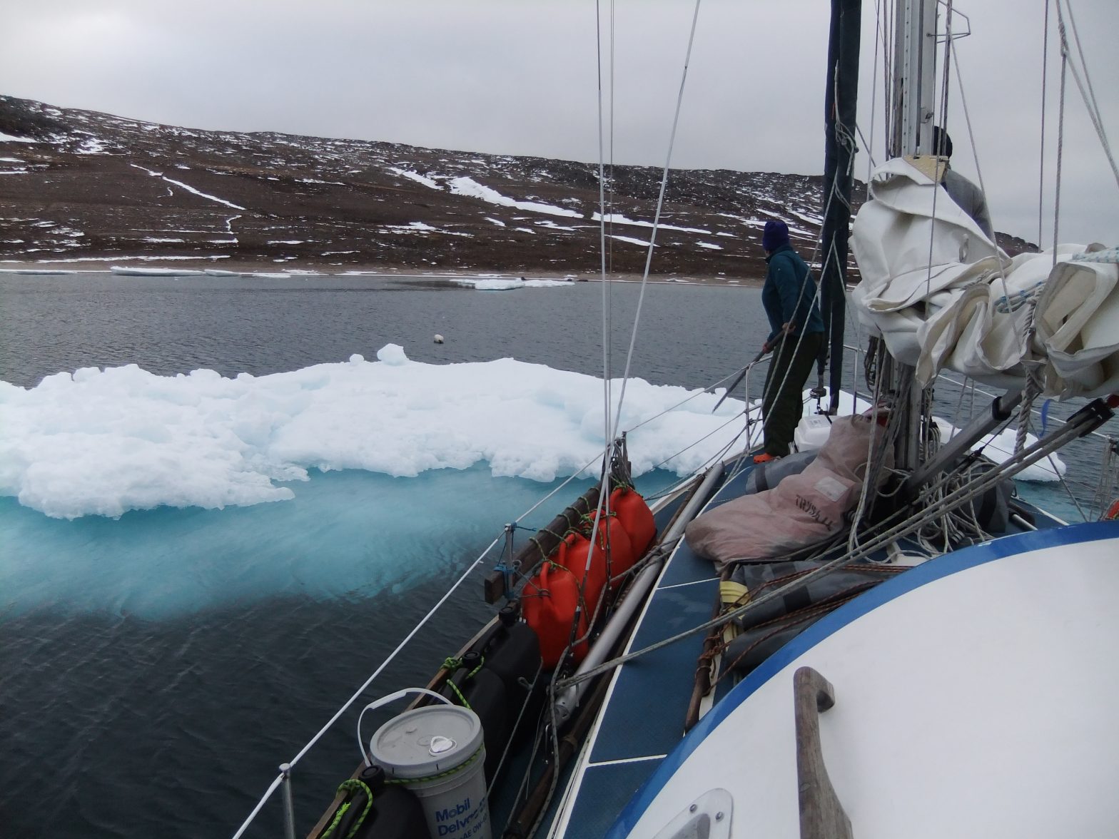 Boat sailing alongside land