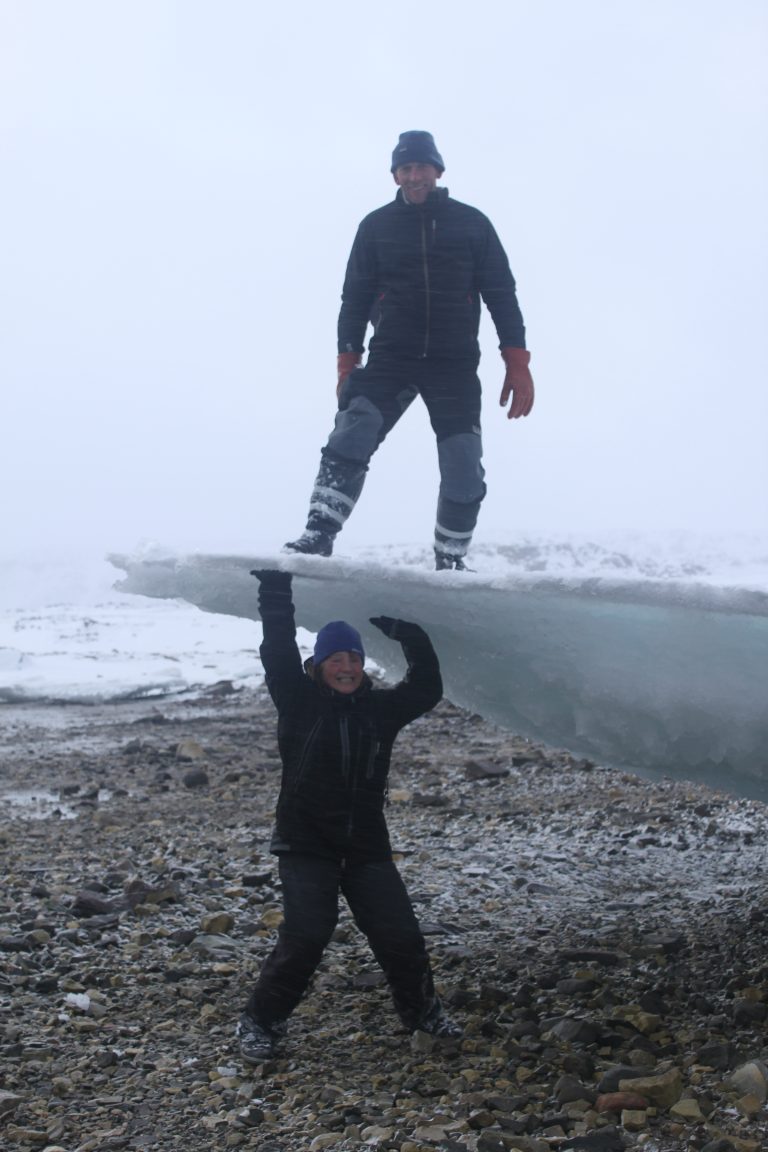 Man standing on ice with another man underneath