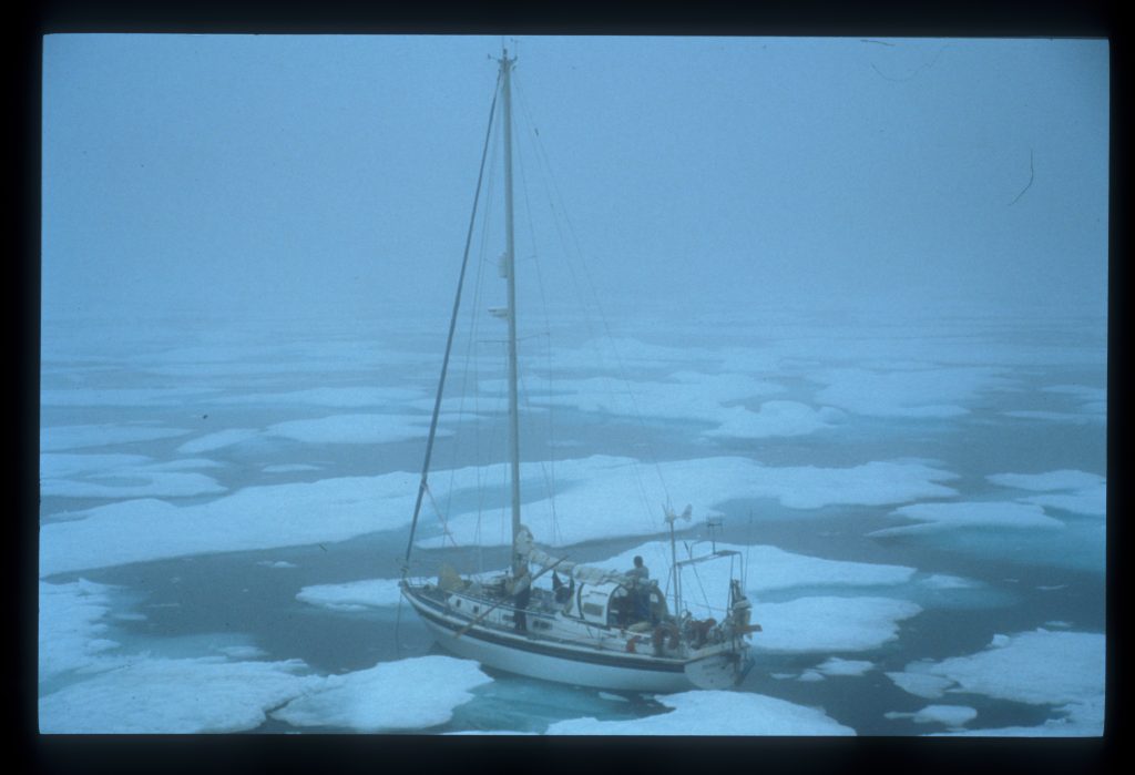 Boat stuck amongst icy water with sunlight faded