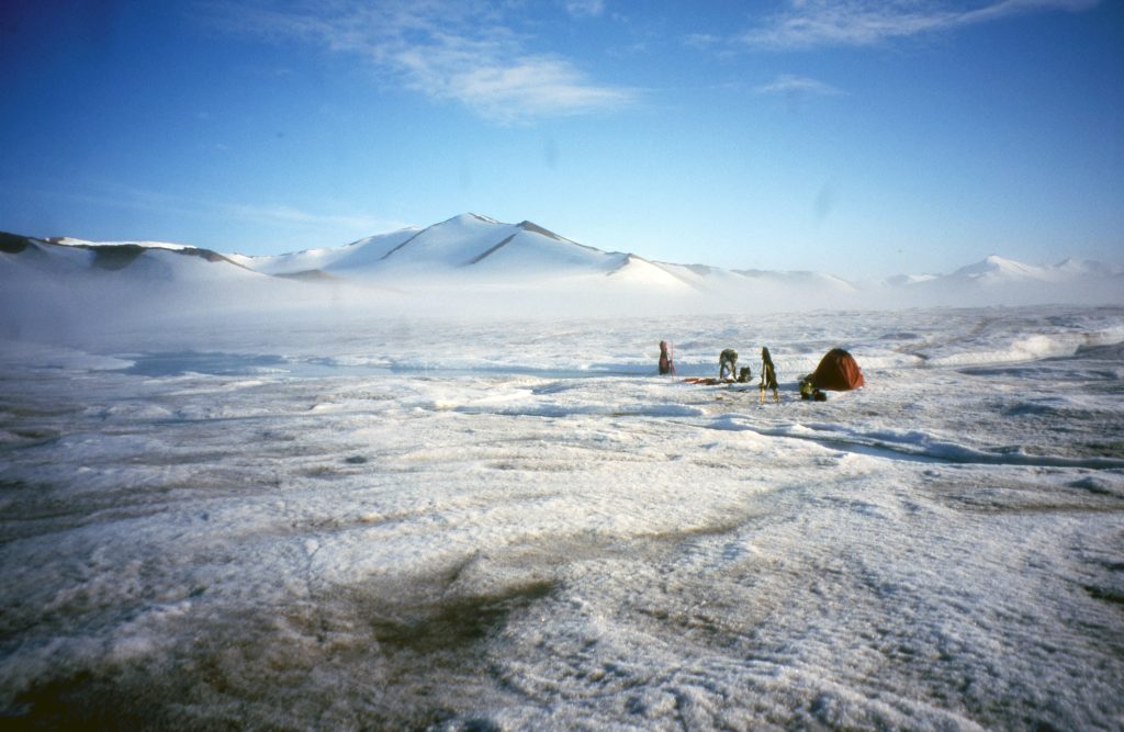 Tent and people camped on the snow